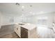 Modern kitchen island with stainless steel sink and dishwasher overlooking the living area at 376 Yellow Finch Ln, Henderson, NV 89012