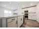 Open kitchen design showcasing a quartz countertop island and stainless-steel appliances at 376 Yellow Finch Ln, Henderson, NV 89012
