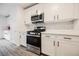 Modern kitchen with stainless steel gas range and microwave with crisp, white cabinetry at 376 Yellow Finch Ln, Henderson, NV 89012