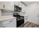 Updated kitchen featuring stainless steel gas range, microwave and white quartz countertops at 376 Yellow Finch Ln, Henderson, NV 89012