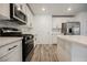 Modern kitchen with stainless steel appliances, quartz countertops, and stylish backsplash at 376 Yellow Finch Ln, Henderson, NV 89012