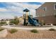 Community playground with climbing and slide features surrounded by desert landscaping and benches for relaxing at 376 Yellow Finch Ln, Henderson, NV 89012