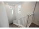 Well-lit staircase with white railing and carpeted steps leading to the lower level at 376 Yellow Finch Ln, Henderson, NV 89012
