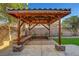 An outdoor cabana with seating sits on a patio surrounded by artifical grass and landscape at 3794 Cape Royal St, Las Vegas, NV 89147