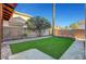 A private backyard features an artificial grass lawn and curated landscaping at 3794 Cape Royal St, Las Vegas, NV 89147