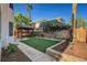 A tranquil backyard oasis includes an artificial lawn and a charming pergola at 3794 Cape Royal St, Las Vegas, NV 89147