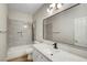 Bathroom features a shower over tub with waterfall shower head, and marble-look vanity at 3794 Cape Royal St, Las Vegas, NV 89147