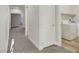 The hallway features neutral walls and carpet with a laundry room and white doors at 3794 Cape Royal St, Las Vegas, NV 89147
