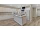 Spacious kitchen featuring an island, stainless appliances, white cabinets, and hardwood flooring at 3794 Cape Royal St, Las Vegas, NV 89147