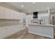 Kitchen with white cabinets, stainless appliances, a large island and wood flooring at 3794 Cape Royal St, Las Vegas, NV 89147