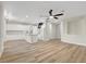 Open-concept living space with white kitchen featuring an island, stainless steel appliances, and modern finishes at 3794 Cape Royal St, Las Vegas, NV 89147