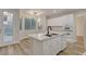 Bright kitchen features an island, white cabinets, stainless appliances, and hardwood flooring at 3794 Cape Royal St, Las Vegas, NV 89147