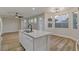 Bright kitchen features an island, modern lighting, hardwood flooring, and neutral paint at 3794 Cape Royal St, Las Vegas, NV 89147