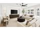 Inviting living room with stylish decor, a modern ceiling fan, and lots of natural light through the windows at 3794 Cape Royal St, Las Vegas, NV 89147