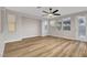 Living room with wood floors, a ceiling fan, bright windows, and a glass door to the backyard at 3794 Cape Royal St, Las Vegas, NV 89147