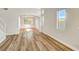 Bright living room with wood floors, white walls, and natural light from large windows at 3794 Cape Royal St, Las Vegas, NV 89147