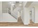 Bright, split staircase featuring white railings and wood flooring leading to the upper levels of the home at 3794 Cape Royal St, Las Vegas, NV 89147