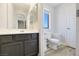 Bright bathroom features gray vanity with drawers and wood-look vinyl flooring at 3961 Bayamon St, Las Vegas, NV 89129