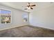 This bedroom features a ceiling fan, carpet, and two windows for natural light at 3961 Bayamon St, Las Vegas, NV 89129
