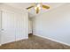 This bedroom features a ceiling fan, carpet, and a large sliding door closet at 3961 Bayamon St, Las Vegas, NV 89129