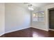 Cozy bedroom featuring hardwood floors, a large window, and modern lighting at 3961 Bayamon St, Las Vegas, NV 89129