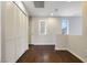 Open hallway with wood flooring, neutral paint, and closet doors at 3961 Bayamon St, Las Vegas, NV 89129