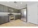 Well-lit kitchen featuring stainless steel appliances, gray cabinets, and tile flooring at 3961 Bayamon St, Las Vegas, NV 89129