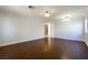Hardwood floors complement a spacious living area, enhanced by stylish lighting and neutral walls at 3961 Bayamon St, Las Vegas, NV 89129