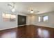 Spacious living room featuring hardwood floors, ample natural light, and modern lighting fixtures at 3961 Bayamon St, Las Vegas, NV 89129