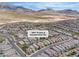 Areal photograph of a community showcasing houses, street access, desert views, and mountain views at 397 Purple Sandpiper St, Las Vegas, NV 89138