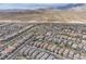Areal View of a community showcasing its access to streets, housing, desert, and mountain views at 397 Purple Sandpiper St, Las Vegas, NV 89138