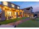 A spacious backyard featuring pavers, artificial turf, covered patio, outdoor seating, and string lights at 397 Purple Sandpiper St, Las Vegas, NV 89138