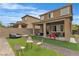 Spacious backyard featuring a covered patio, artificial turf, seating area, and paved pathway at 397 Purple Sandpiper St, Las Vegas, NV 89138