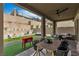 Backyard featuring an outdoor dining area, lounge seating, and lush landscaping at 397 Purple Sandpiper St, Las Vegas, NV 89138