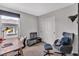 Bedroom featuring a desk, window, an accent chair and sliding closet doors at 397 Purple Sandpiper St, Las Vegas, NV 89138
