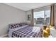 Bright bedroom with a large window offering natural light and a comfortable bed at 397 Purple Sandpiper St, Las Vegas, NV 89138