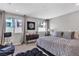 Stylish bedroom featuring two windows, decorative lamps, and a large bed with accent pillows at 397 Purple Sandpiper St, Las Vegas, NV 89138