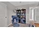 Bright bedroom area featuring accent chair, ottoman, bookshelves and closet at 397 Purple Sandpiper St, Las Vegas, NV 89138
