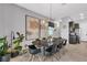 Bright dining area with modern light fixture and adjacent kitchen featuring stainless steel appliances at 397 Purple Sandpiper St, Las Vegas, NV 89138