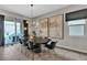 Dining room with modern chandelier, black marble table, and view of the outdoor patio at 397 Purple Sandpiper St, Las Vegas, NV 89138