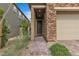 Close-up view of a home's front entrance, showcasing the stone accents and brick pathway at 397 Purple Sandpiper St, Las Vegas, NV 89138