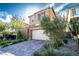 Charming two-story home with a stone facade, brick driveway, and desert-friendly landscaping at 397 Purple Sandpiper St, Las Vegas, NV 89138
