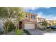 Charming two-story home featuring a stone facade, desert landscaping, and a brick paved driveway at 397 Purple Sandpiper St, Las Vegas, NV 89138