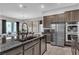 Modern kitchen with stainless steel appliances, granite countertops, and a view into the living area at 397 Purple Sandpiper St, Las Vegas, NV 89138