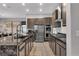 Modern kitchen with stainless steel appliances, granite countertops, and light brown cabinets at 397 Purple Sandpiper St, Las Vegas, NV 89138