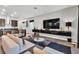 Living room with TV, floating console, modern decor, seating, and view into kitchen area at 397 Purple Sandpiper St, Las Vegas, NV 89138