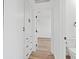 Well-lit bathroom with white cabinetry, black hardware and an open doorway to a bedroom at 429 N 10Th St, Las Vegas, NV 89101