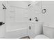 Bright bathroom featuring white fixtures, black hardware and a combination shower and tub at 429 N 10Th St, Las Vegas, NV 89101