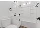Clean white bathroom featuring white sink, bathtub with white tile, and black hardware at 429 N 10Th St, Las Vegas, NV 89101