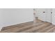 Bedroom featuring light hardwood floors, white walls and two white doors with black hardware at 429 N 10Th St, Las Vegas, NV 89101